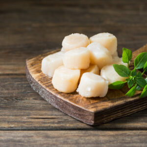 Raw,Scallops,On,Wooden,Board,On,Wooden,Background